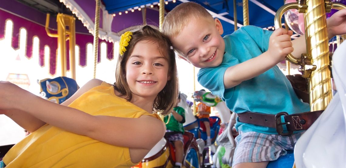 Two kids on a merry-go-round.